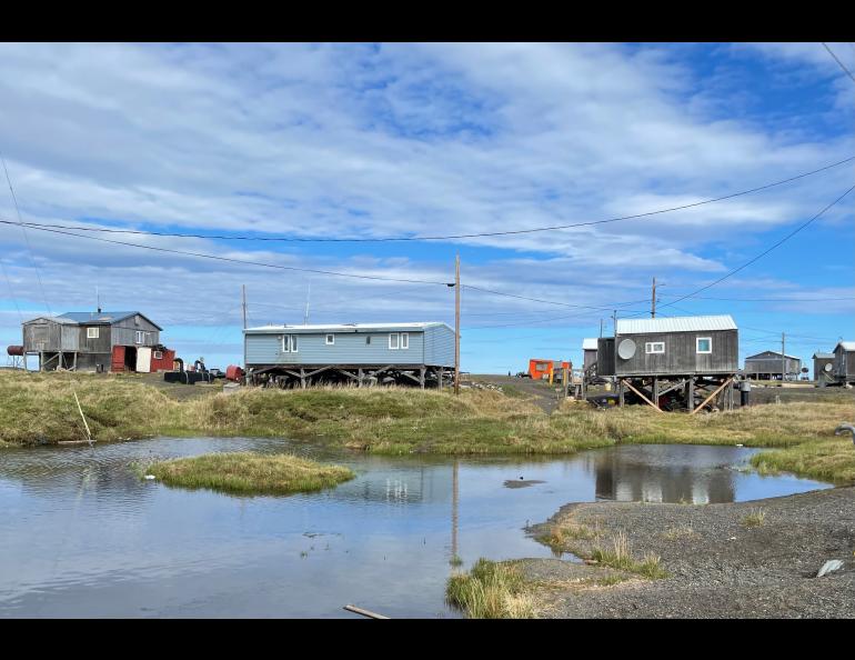 Most of Point Lay’s residential area sits on permafrost that is rapidly thawing. The subsiding ground exposes more of each building’s support pilings. UAF photo by Benjamin Jones