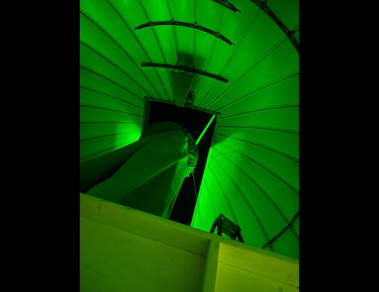  A light beam produced by the new lidar is seen from inside the dome at the Subauroral Geophysical Observatory at Gakona. Photo by Mike Roddewig