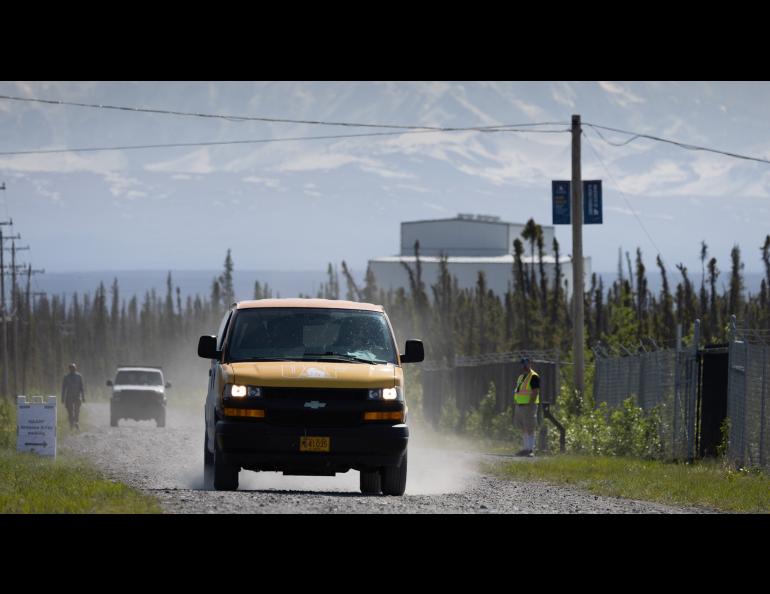 A useful addition to this year's open house was a UAF shuttle van between the HAARP Operations Center in the background, and the antenna array, which is about a mile away. Visitors could also drive themselves or walk to the array. Photo by Bryan Whitten