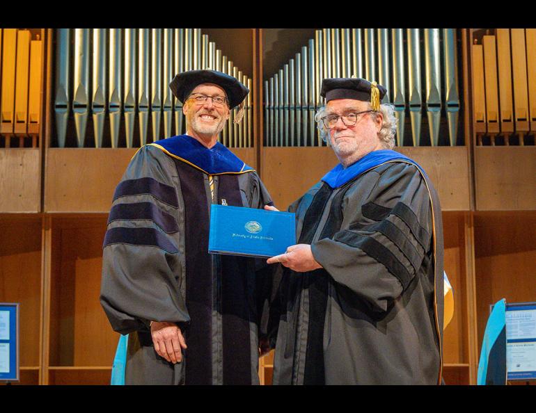 Dr. Bernard J. Coakley, Professor of Geophysics, is honored for reaching emeritus status by Chancellor Dan White at the Honoree Recognition Ceremony in the Davis Concert Hall, Friday, May 2nd, 2025. UAF photo by Leif Van Cise