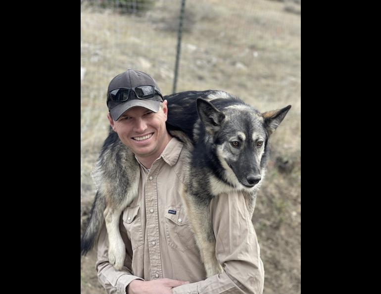 One of Michael Rottewig’s sled dogs, Raven, likes to be carried around on his shoulders. Photo courtesy Michael Roddewig