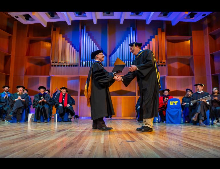 Chancellor Mike Sfraga congratulates Don Hampton on his appointment as Research Professor of Space Physics, Emeritus. Photo by Eric Engman