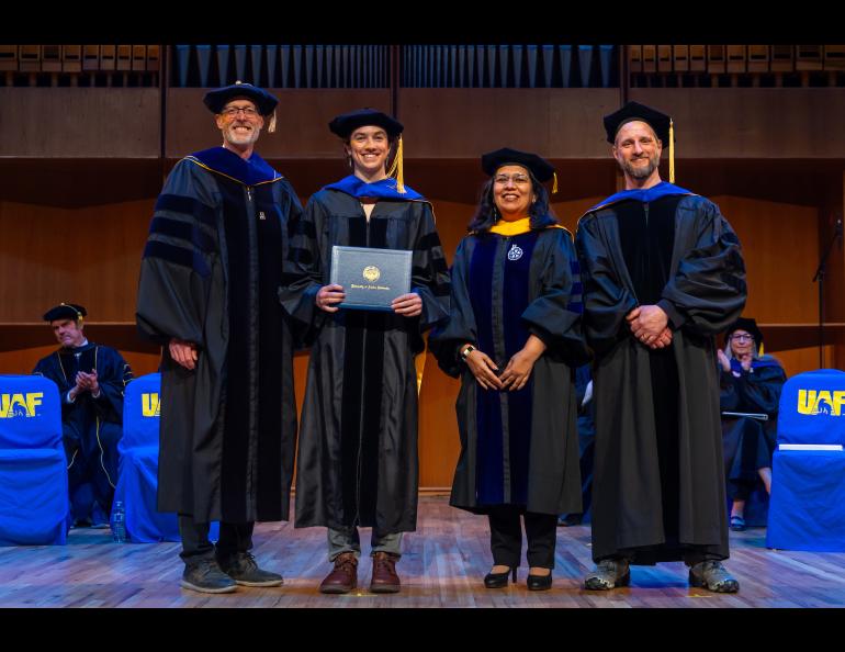 UAF Chancellor Dan White and Provost and Executive Vice Chancellor Anupma Prakash pose with Emily Fedders during the 2025 Ph.D. Hooding Ceremony in the Davis Concert Hall on the UAF campus, Friday, May 2, 2025. Fedders earned a Ph.D. in Geophysics. She is escorted by Dr. Andrew Mahoney, right. UAF photo by Eric Engman