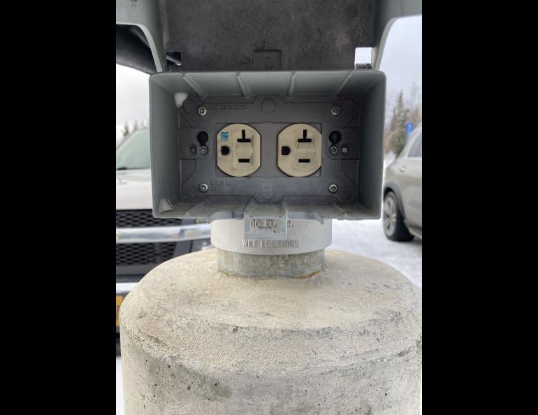 This block heater plug-in can accommodate TWO cars, so please park to the right or the left of it.