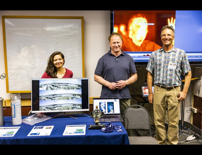 Telayna Wong, Martin Stuefer and Carl Schutt gather for a photo in front of their display at the Elvey Building's Globe Room. UAF/GI photo by JR Ancheta.