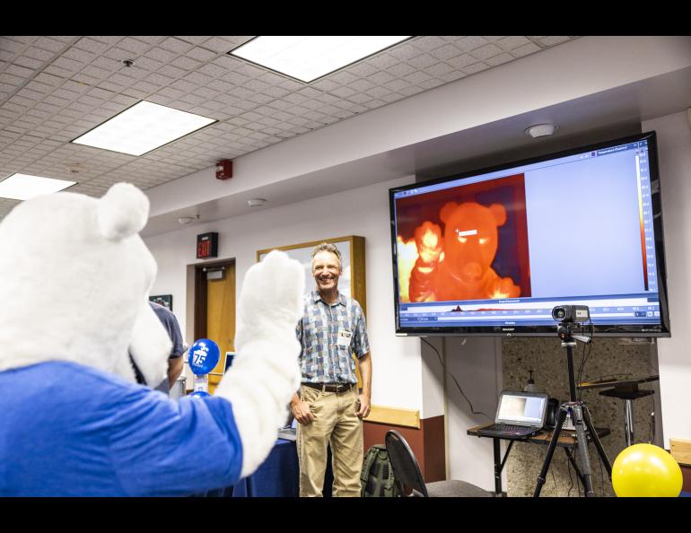 The Nook waves into a forward-looking infrared camera at the Geophysical Institute's Globe Room at the Elvey Building during the 2023 Arctic Research Open House. UAF/GI photo by JR Ancheta.