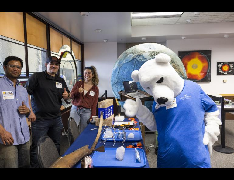 The Nook visits the Snow, Ice and Permafrost group's table during the 2023 Arctic Research Open House at the Troth Yeddha' campus at the Geophysical Institute. UAF/GI photo by JR Ancheta.