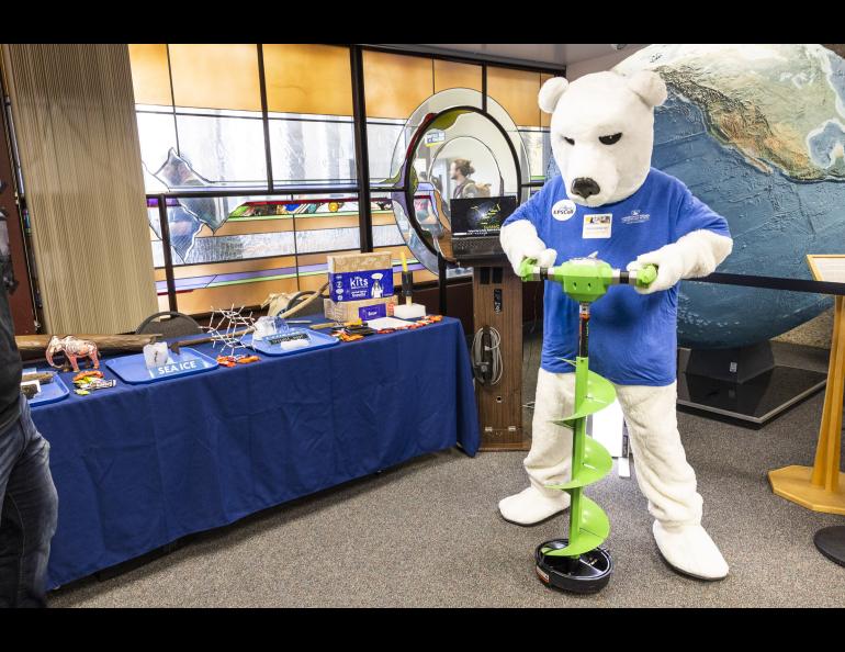 The Nook is ready to drill ice as he visists the Snow, Ice and Perrmafrost group's table during the 2023 Arctic Research Open House at the Troth Yeddha' campus at the Geophysical Institute. UAF/GI photo by JR Ancheta.