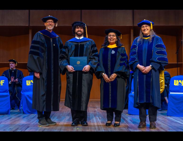UAF Chancellor Dan White and Provost and Executive Vice Chancellor Anupma Prakash pose with Jamshid Moshrefzadeh during the 2025 Ph.D. Hooding Ceremony in the Davis Concert Hall on the UAF campus, Friday, May 2, 2025. Moshrefzadeh earned a Ph.D. in Geoscience. They are escorted by Dr. Jessica Larsen, right. UAF photo by Eric Engman