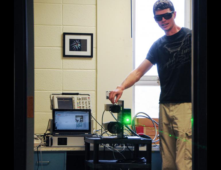 Michael Roddewig aligning the fish lidar he developed as a grad student at Montana State University, circa 2014. Photo courtesy Joseph Shaw