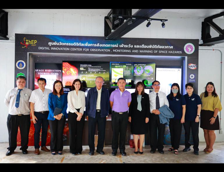 Chiang Mai University President Pongruk Sribanditmongkol, center, in purple shirt, visited the Space Weather Monitoring War Room. Dr. Wongratanaphisan (3rd from left) is the acting executive director of the Thailand Center of Excellence in Physics, Dr. Komonjinda (4th from the left) is the PI for space weather research, Dr. Wannawichian (far right) is working on auroral analysis, and Dr. Nuntiyakul (3rd from right) is lead researcher for cosmic ray and neutrino observations. Photo courtesy CMU