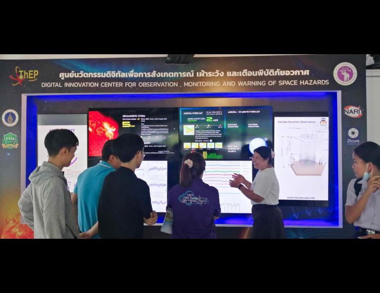 Suwicha Wannawichian of Chiang Mai University, Thailand, explains the data displayed on the monitors to young researchers and graduate students. She was inviting them to join space physics research. Photo courtesy Chiang Mai University