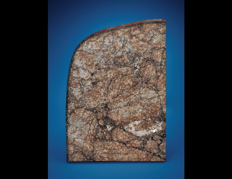 A section of the Peekskill meteorite, including red paint from the Chevy Malibu it passed through.