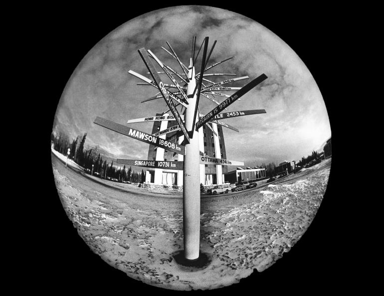 An early fisheye photo of the signpost probably taken not long after it was installed. Geophysical Institute photo.