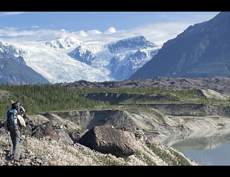 From left, Martin Truffer and Adam Bucki walk along the gravel moraine of Kennicott Glacier on an 11-hour hike to reach Fireweed rock glacier. Photo by Ned Rozell.