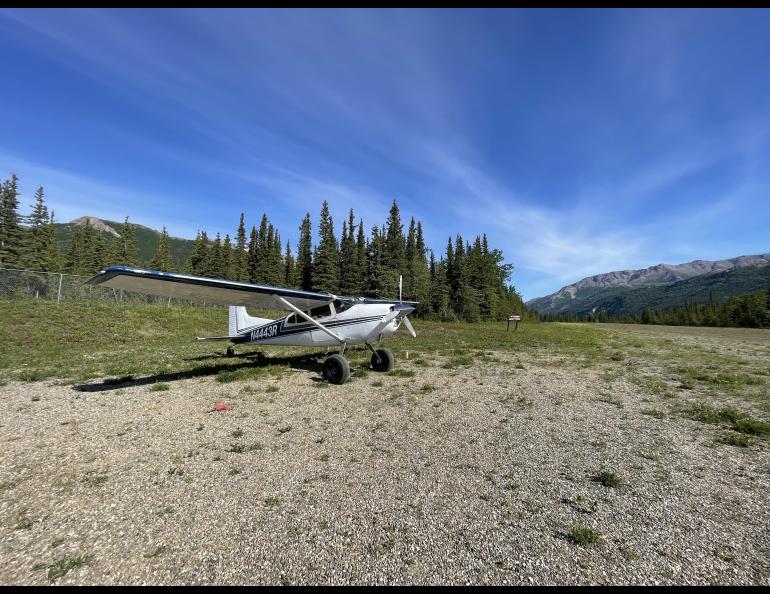 Small airplane on gravel runway