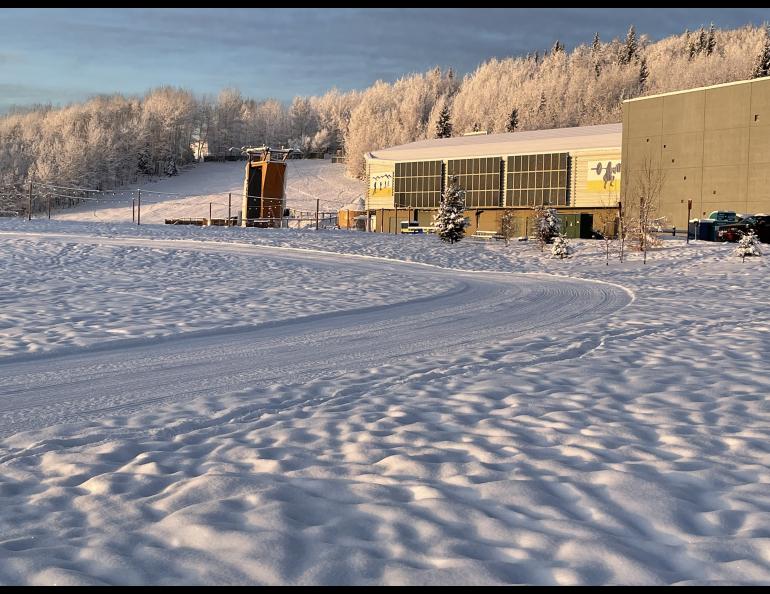 December sunshine lights a freshly groomed cross-country ski trail and the Student Recreation Center at the University of Alaska Fairbanks. Photo by Ned Rozell.