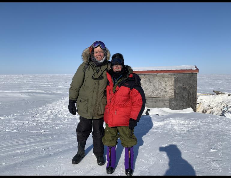 George Divoky and his friend Matt Thomas pose in front of Divoky’s cabin on Cooper Island after repairing polar-bear damage in April, 2022. Photo by Craig George.