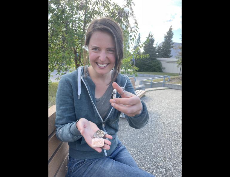 Kelsey Aho shows ceramic tiles she created from minerals gathered around Alaska. Ned Rozell photo.
