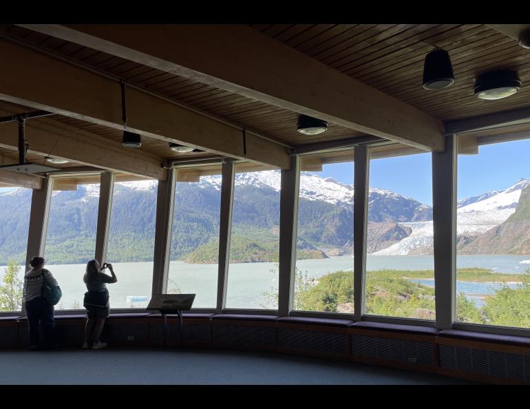 Visitors take images of Mendenhall Glacier near Juneau in summer 2022 from inside the Mendenhall Glacier Visitor Center. Photo by Ned Rozell.