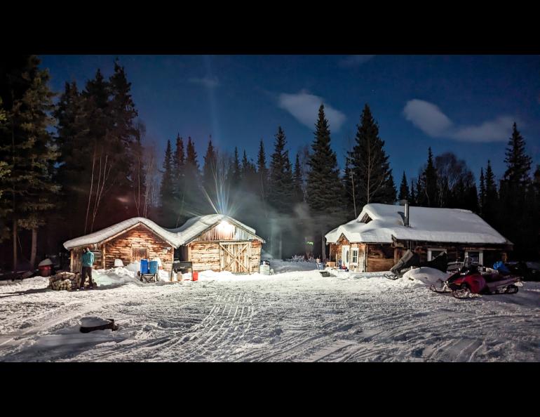 Iditarod checkpoint volunteers turned a light on in the ghost town of Ophir during the 2023 race. Photo by Jay Cable.