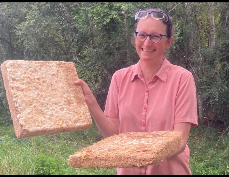 Engineer Robbin Garber Slaght holds prototype insulation panels made of wood fiber held together by a fungus species. Photo by Molly Rettig.
