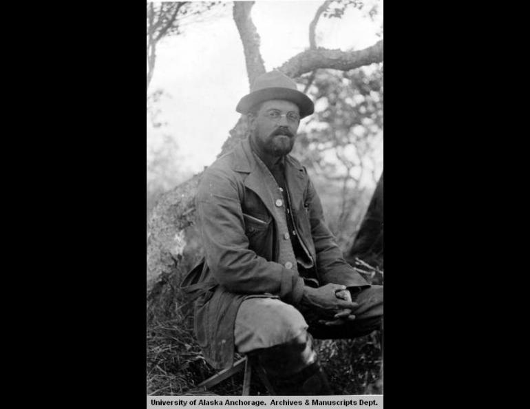 In 1917, botanist and expedition leader Robert Griggs sits at the National Geographic Society Base Camp in what later became Katmai National Park and Preserve, Alaska. Photo by D.B. Church.