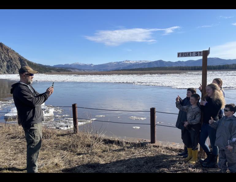 Ryan Becker, a teacher at the Eagle school, takes a photo of his students as part of a continuing Yukon River ice study on May 12, 2023. Photo by Ned Rozell.