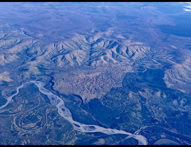 A vegetated sand dune that formed between the Tanana River, Interior Alaska hills and the Taylor Highway, as seen from a flight from Seattle to Fairbanks. The Alaska Highway Bridge over the Tanana River is visible at bottom. Photo by Ned Rozell.