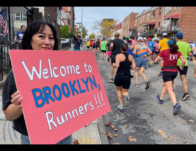 A woman welcomes runners to Brooklyn during the New York City Marathon on Nov. 6, 2022. Photo by Ned Rozell.