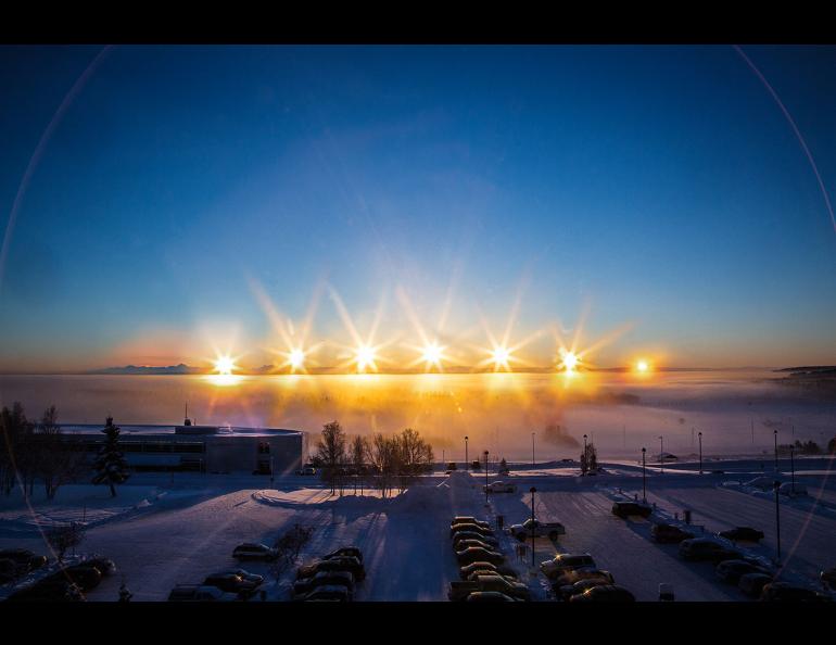 A multiple-exposure photo of the winter-solstice sun arcing over the Alaska Range, taken from the University of Alaska Fairbanks campus on Dec. 21, 2012. Photo by Todd Paris.