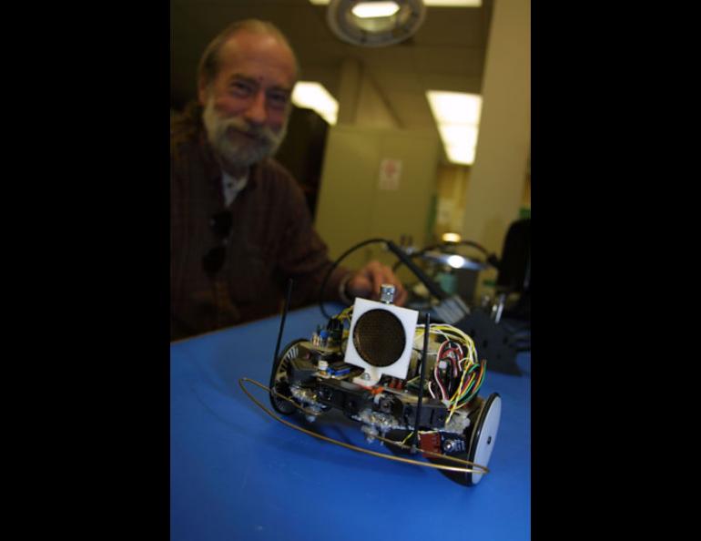 Rick Ruhkick, an engineering technician with the Geophysical Institute’s electronics shop, watches his robot Sparky.
