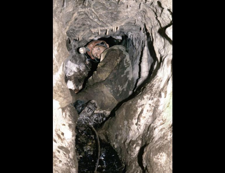 Fred Grady of the Department of Paleobiology at the Smithsonian Institution crawls into On Your Knees Cave in southeast Alaska, where Tim Heaton found the oldest known human remains in Alaska or Canada in 1996. Heaton, of the University of South Dakota, will return to Southeast limestone caves this summer. Tim Heaton photo.