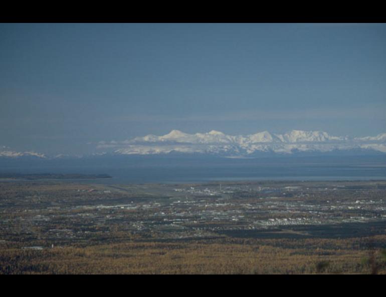 Photo: Mount Spurr, the tallest of the mountains in this photo taken from the hills east of Anchorage, blacked out the city with ash 50 years ago in the first interaction between a volcano and urban Alaska. Photo by Game McGimsey.