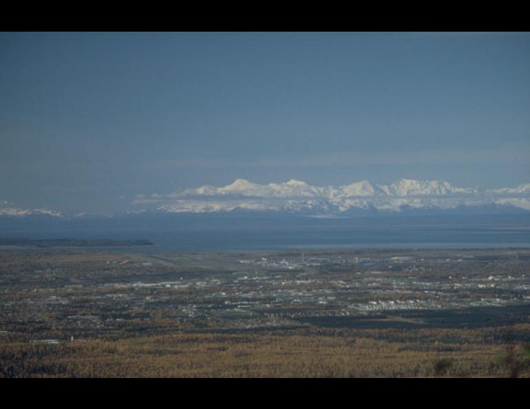  Photo: Mount Spurr, the tallest of the mountains in this photo taken from the hills east of Anchorage, blacked out the city with ash 50 years ago in the first interaction between a volcano and urban Alaska. Photo by Game McGimsey. 