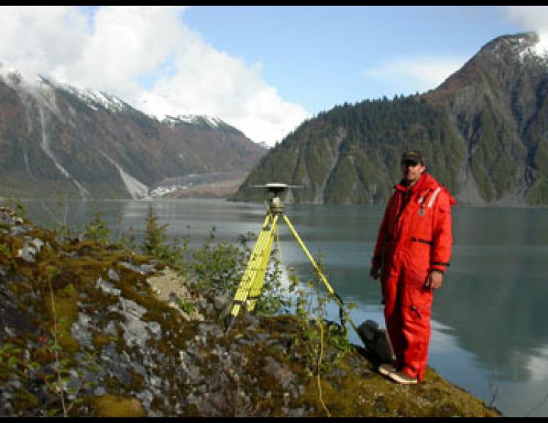  Geophysical Institute research assistant Adam Bucki stands next to a GPS antenna at one of 76 spots in southeast Alaska. Scientists are using the sites, such as this one in Lituya Bay, to find that Southeast is one of the fastest-rising areas on Earth. Photo by Ned Rozell. 