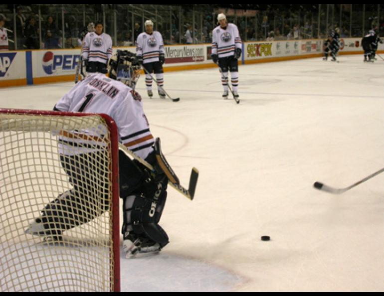 Anchorage native Ty Conklin turns away a shot from an Edmonton Oiler teammate before a December 2003 game against the San Jose Sharks. Photo by Ned Rozell.