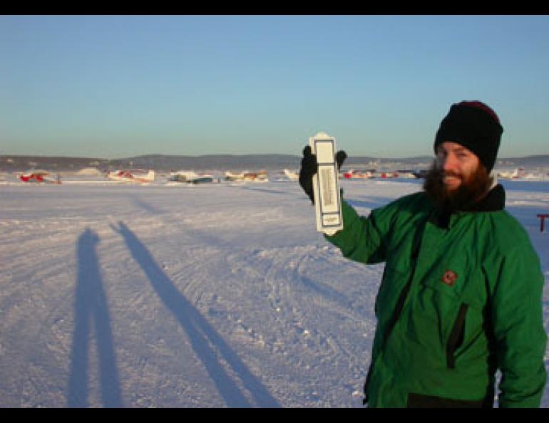 Fairbanks meteorologist Jim Brader measures 30 below zero at Fairbanks International Airport, often one of the coldest spots in town during a temperature inversion. Ned Rozell photo.