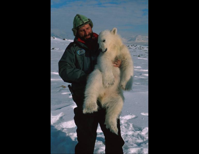  Andrew Derocher of the University of Alberta holds a polar bear cub captured during a study in Svalbard, Norway. Photo courtesy Andrew Derocher 