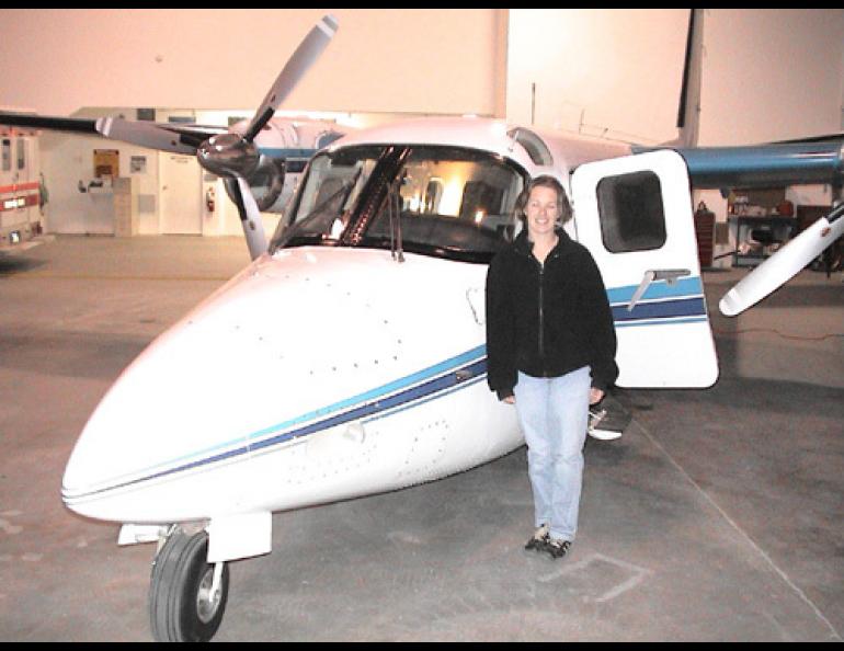  NOAA pilot Cathy Martin and her flying machine, a twin-engine Turbocommander AC-690. Photo by Ed Plumb. 