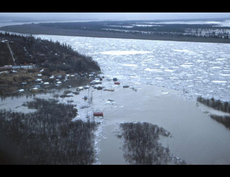 An ice jam in the lower Yukon backed the river into the village of Russian Mission in 1989. Floodwaters remained in the village for one week, when the only way in or out was by helicopter. Photo by Larry Rundquist, Alaska-Pacific River Forecast Center.
