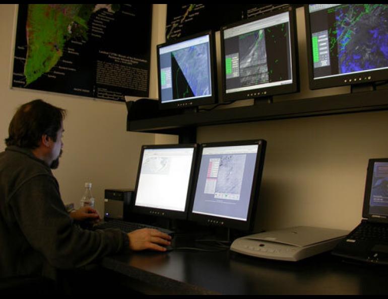 Jon Dehn of the Alaska Volcano Observatory looks at satellite images a few hours after an explosive eruption on Augustine Volcano in Cook Inlet on January 17, 2006. Ned Rozell photo.