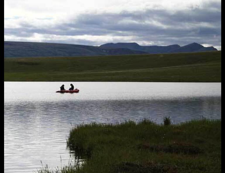  Scientists sample water from a lake on Alaska’s North Slope, where they recently found that the sun converts mercury into a form that fish don’t pick up. Photo by William Fitzgerald. 