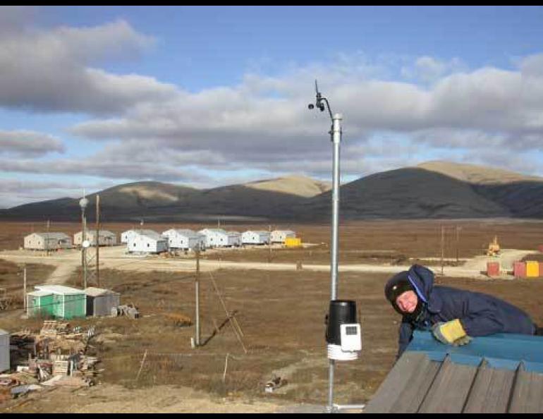  Hal Needham of the University of Alaska’s Geophysical Institute installs a weather station on the Brevig Mission School as part of the Arctic Climate Modeling Program. Photo by Ned Rozell. 