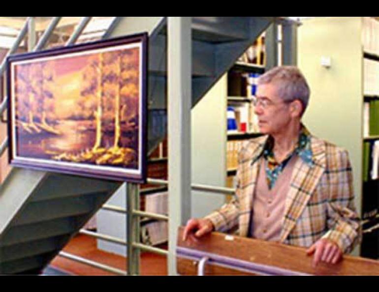 Jim Anderson poses next to one of his 300 junk store artworks in the University of Alaska Fairbanks’ Biosciences Library in 2004. Photo courtesy of Tom Delaune.