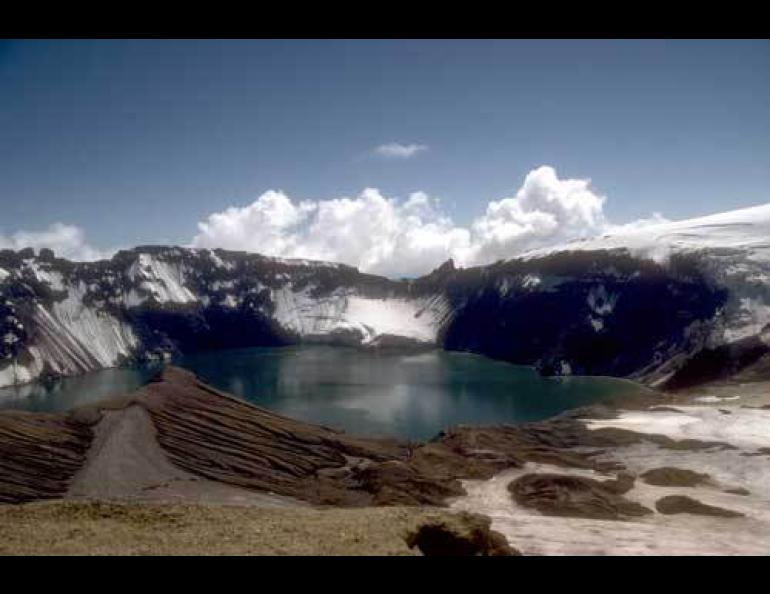View from the north rim of Katmai Caldera, a collapse feature that formed during the catastrophic eruption in June of 1912. Katmai Caldera is partially filled by a blue-green lake that is more than 800 feet deep. Photo by R. McGimsey, U.S. Geological Survey, courtesy of the Alaska Volcano Observatory and the U.S. Geological Survey.