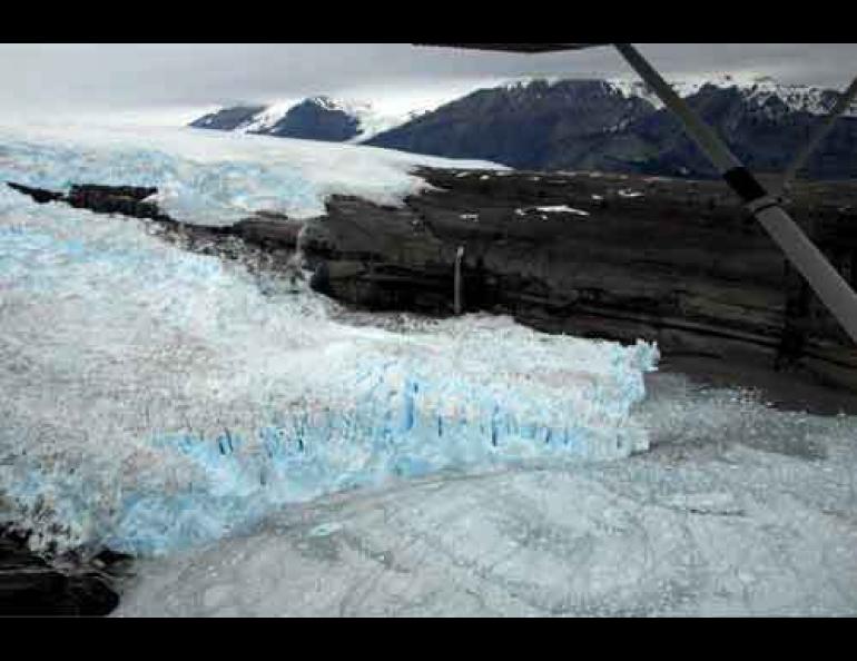 The terminus of Tsaa Glacier in June 2007 after a recent advance of the glacier. Note the position of the large waterfall. The glacier advanced about one-third of a mile sometime between August 2006 and June 2007. Photo by Chris Larsen, Geophysical Institute, UAF.