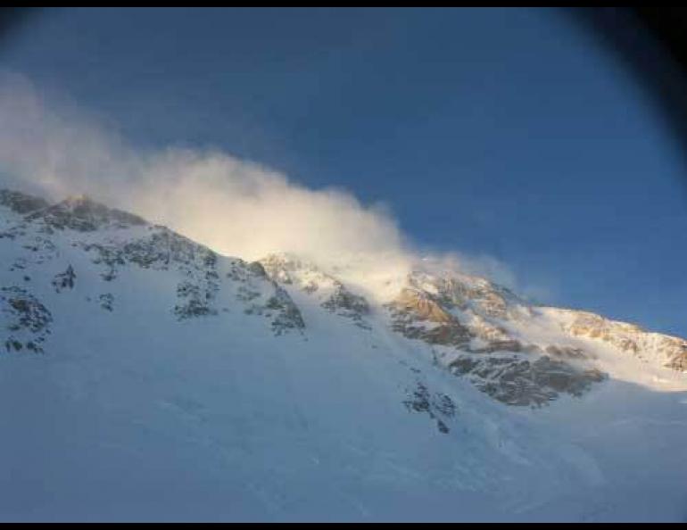 High winds move snow on a ridge of Mount McKinley. A team of climbers from the International Arctic Research Center and the Japan Alpine Club faced difficult weather on the 2007 expedition to a weather station. Photo by Tohru Saito, International Arctic Research Center.