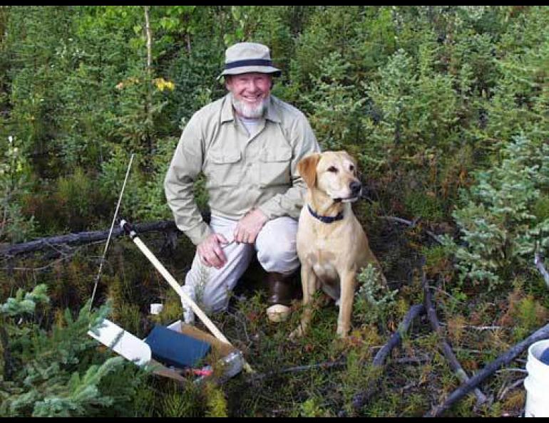 Tom Osterkamp with his Labrador retriever Happy at a permafrost-monitoring site near Bonanza Creek west of Fairbanks in 1999. Photo courtesy Tom Osterkamp.