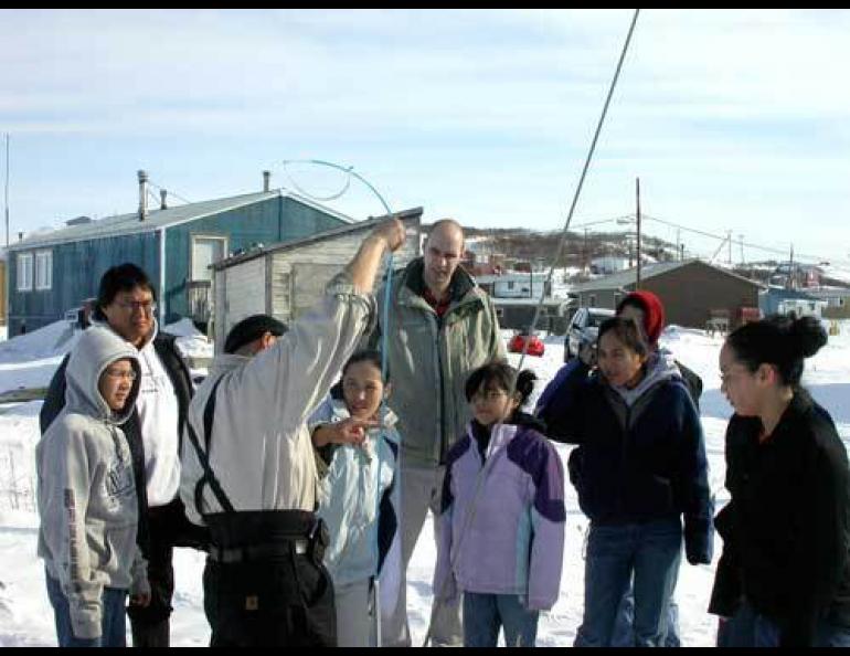 Kenji Yoshikawa shows Golovin students a “frost tube” he installed behind their school. Photo by Ned Rozell.